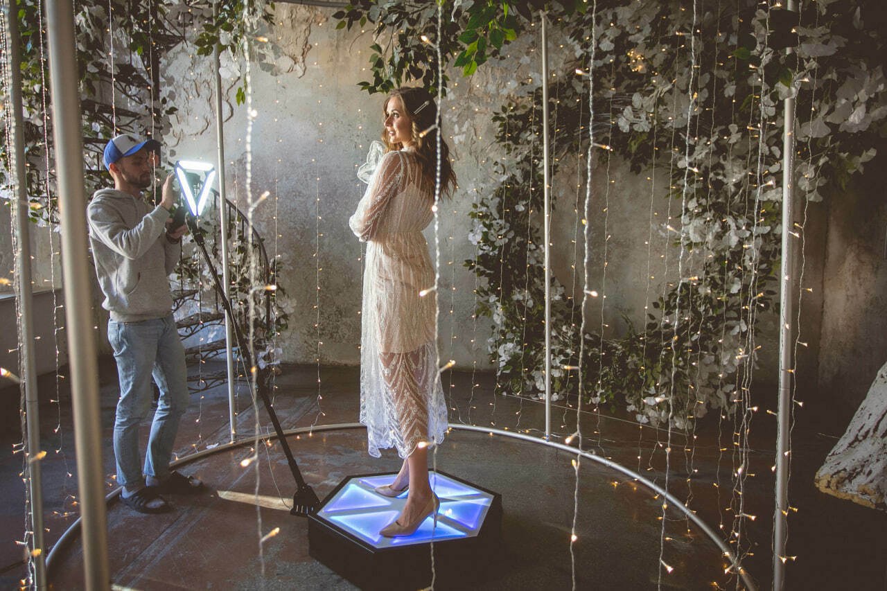An operator filming a guest on Spinner 360 in an event space